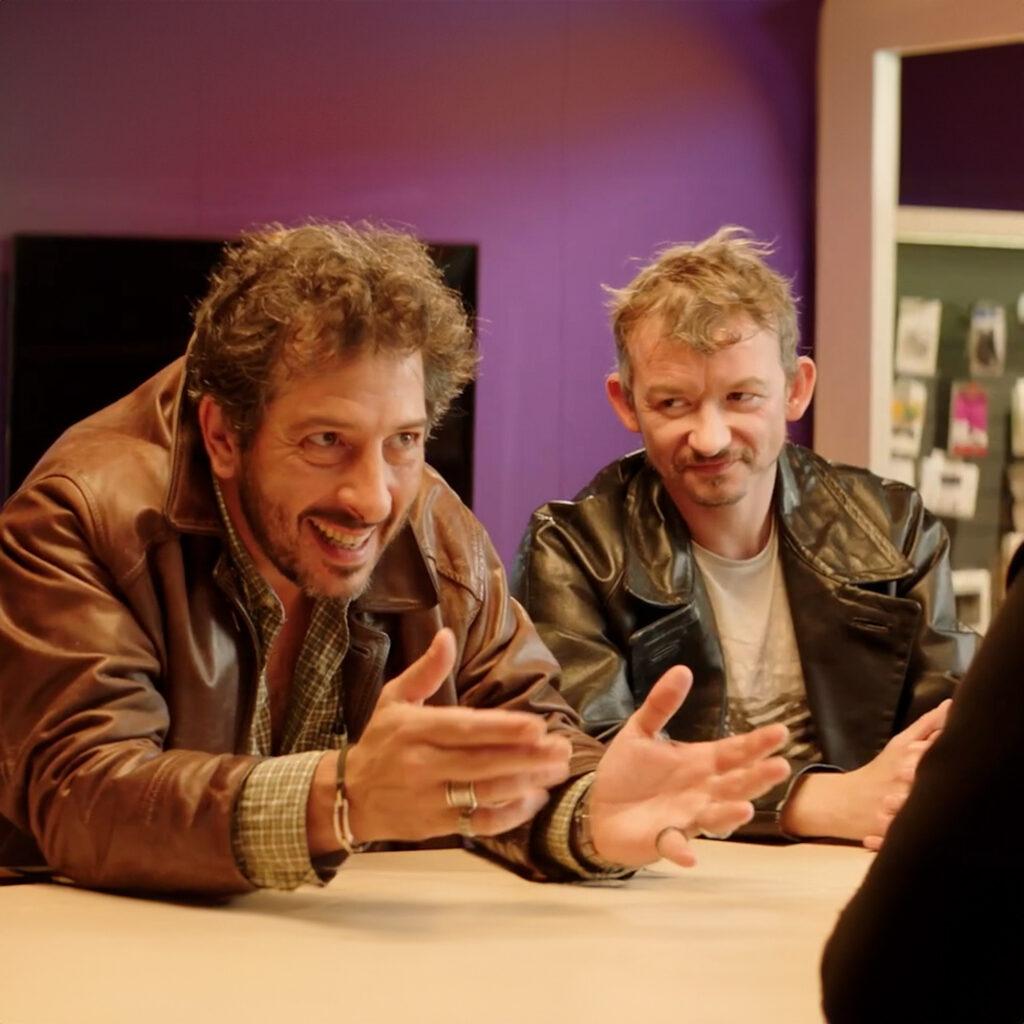 a group of men sitting at a table